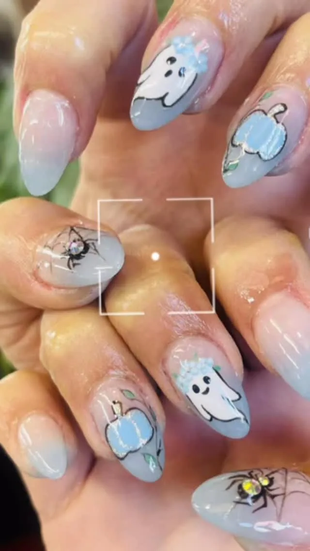 Hand-painted Halloween nails — ghosts, spiders and blue pumpkins on a grey base